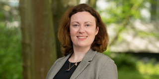 You can see a portrait photo of Prof. Anna Isaeva with trees in the background