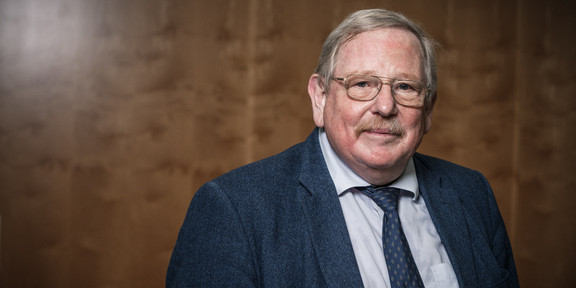 Portrait eines älteren Herren (Prof. Reinhard Genzel) mit Brille, Anzug und Krawatte.