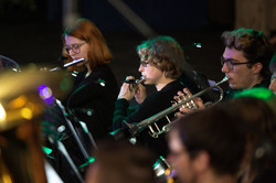 Two people who play the flute and one who plays the trumpet.