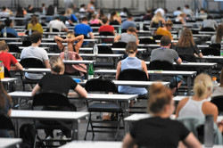 Exam in the Westfalenhalle exhibition center Many students sitting at tables.