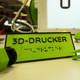 Ein Schild auf dem "3D-Drucker" steht.