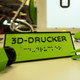 Ein Schild auf dem "3D-Drucker" steht.