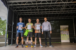 the three fastest runners are on stage, next to them Christoph Edeler, head of university sports