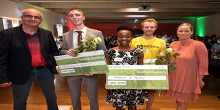 Group photo with the winners of the Global Gallery, each holding a check and flowers.