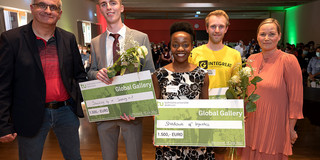 Group photo with the winners of the Global Gallery, each holding a check and flowers.