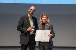 Two people hold up a certificate.