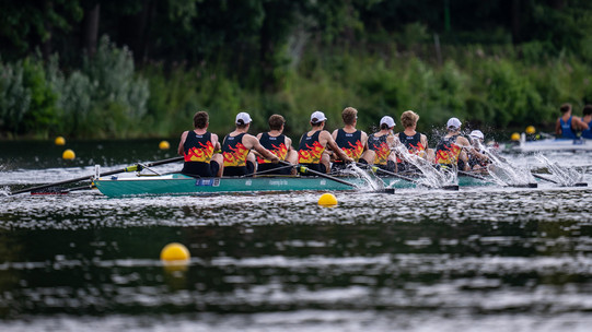 The German men's eight in the final of the FISU Games, back view.