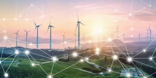 Many wind turbines on a coastline. A schematic network can be seen in the foreground.