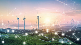 Mai Viele Windräder an einer Küste. Im Vordergrund sieht man ein schematisches Netzwerk.