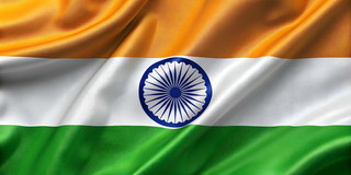 You can see a flag with horizontal stripes in the colors orange, white and green. In the middle is a dark blue circle, which is reminiscent of a mandala on the inside.