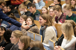 A woman in the audience asks a question.