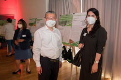Two people stand in front of a poster