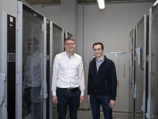 Prof. Johannes Albrecht and Maik Becker Two men standing side by side in a research laboratory.