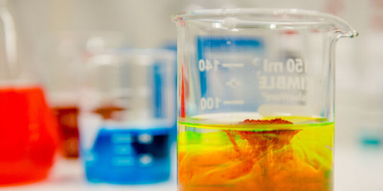 A photo of three test tubes containing colorful liquids.