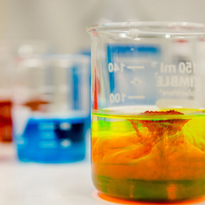 A photo of three test tubes containing colorful liquids.