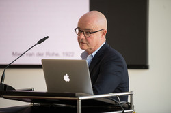 A person gives a lecture to an audience.