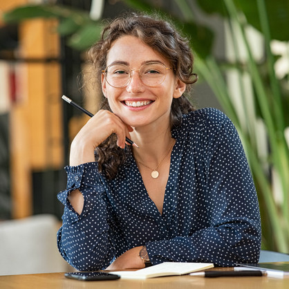 Young woman sitting at desk and smiling