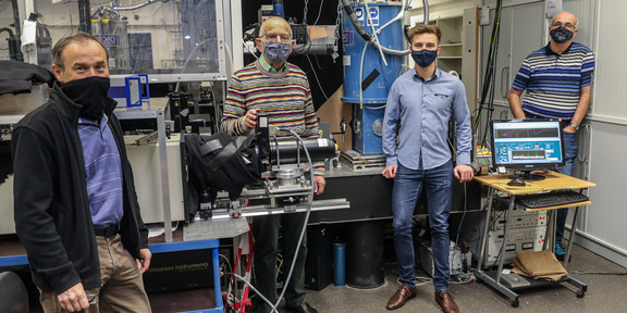 Research team Four men standing in a laboratory