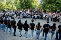 Eine Gruppe für anatolische Volkstänze tritt auf dem Platz vor der Emil-Figge-Straße 50 auf. Vor ihnen tanzt ein Solist, hinter dem das Publikum zu sehen ist.