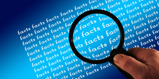 The word "Facts" is written countless times on a blue background. Above it hovers a hand holding a magnifying glass