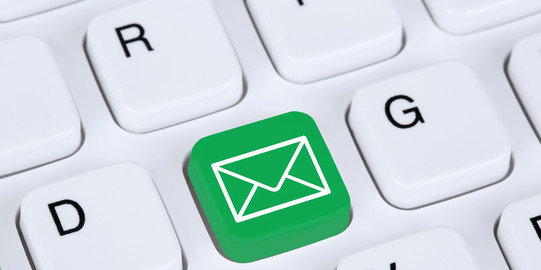 Contact Persons White keyboard and a green key with an email sign