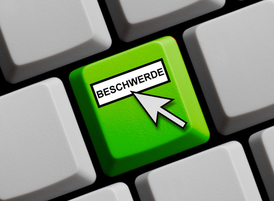 Beschwerde_Taste Eine grüne Taste mit dem Wort Beschwerde und einem hinweisenden Mauspfeil.