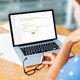 Woman sitting in front of her laptop
