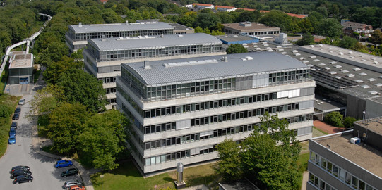 Aerial view of three large white buildings
