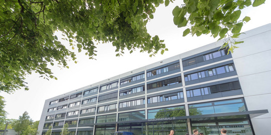A Building with large windows and students passing by